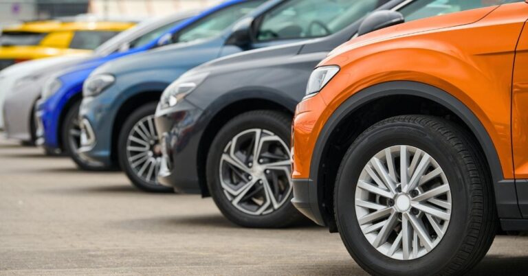 a row of cars at a dealership